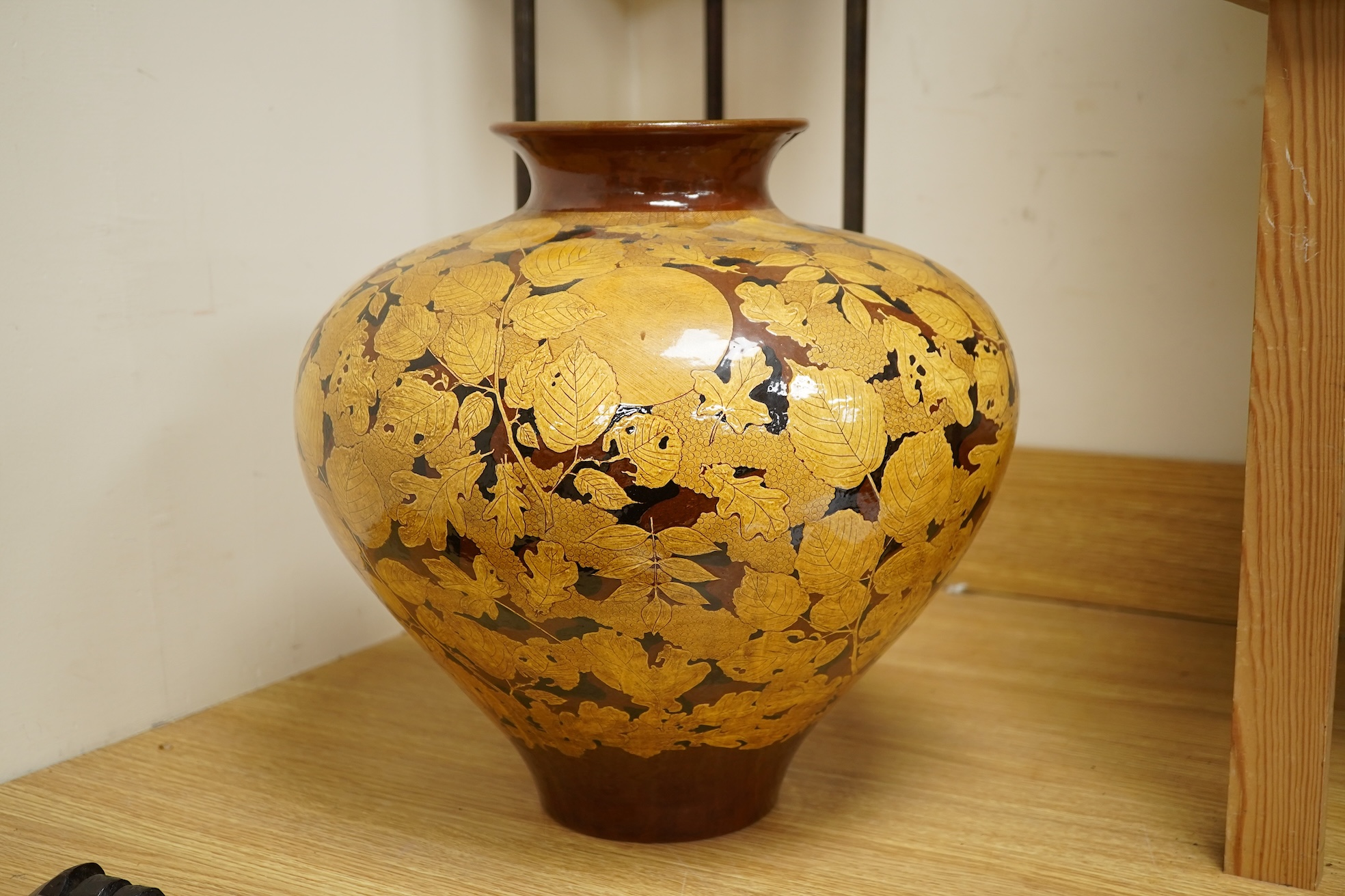 A large terracotta foliaiate decorated vase, 38cm high